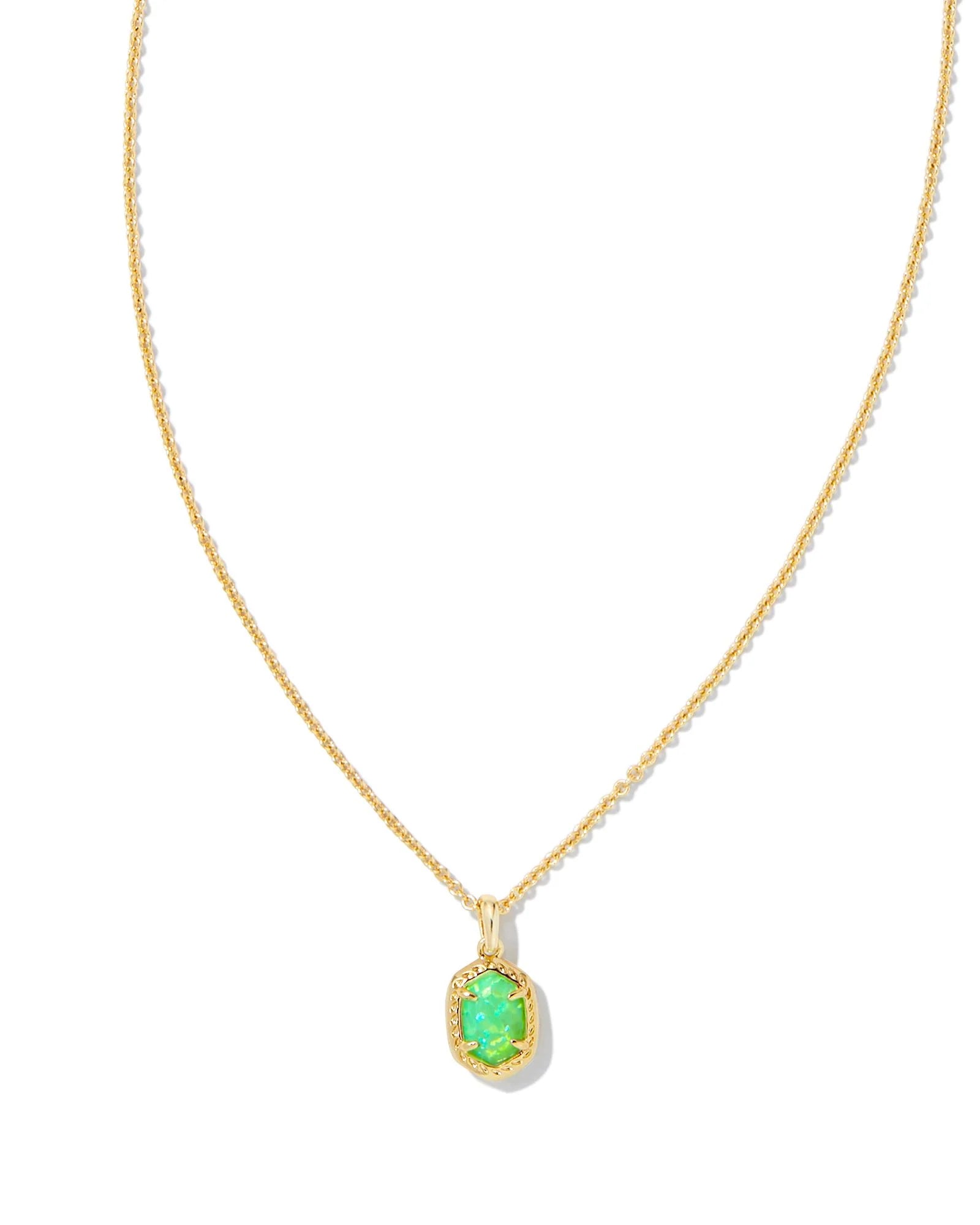 Gold necklace with a green pendant on a white background