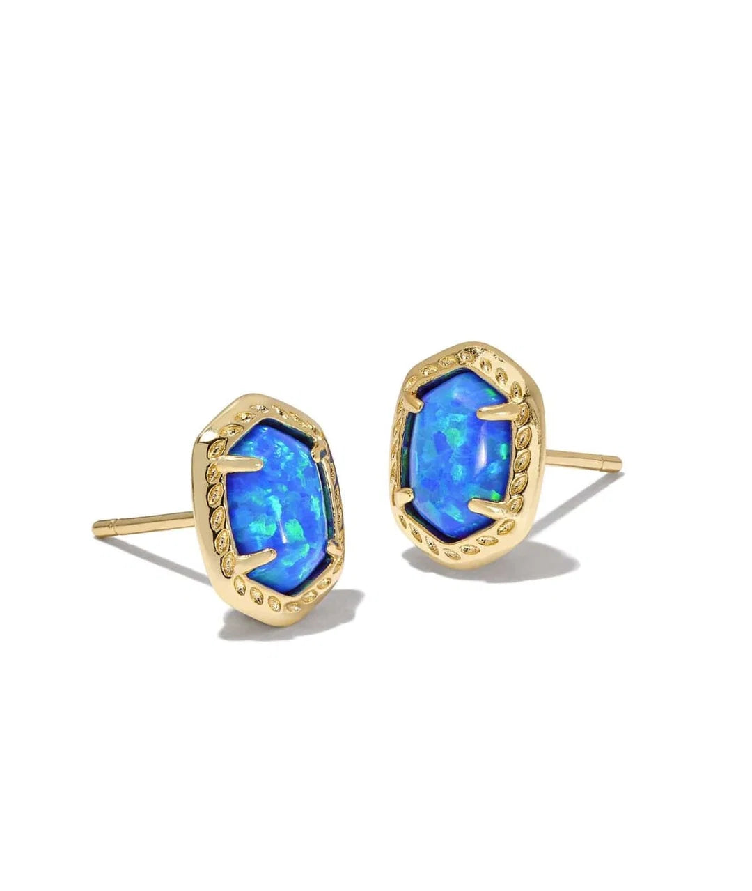 A pair of gold stud earrings featuring irregular, organic-shaped blue opal gemstones in gold bezel settings, shown on a clean white background.