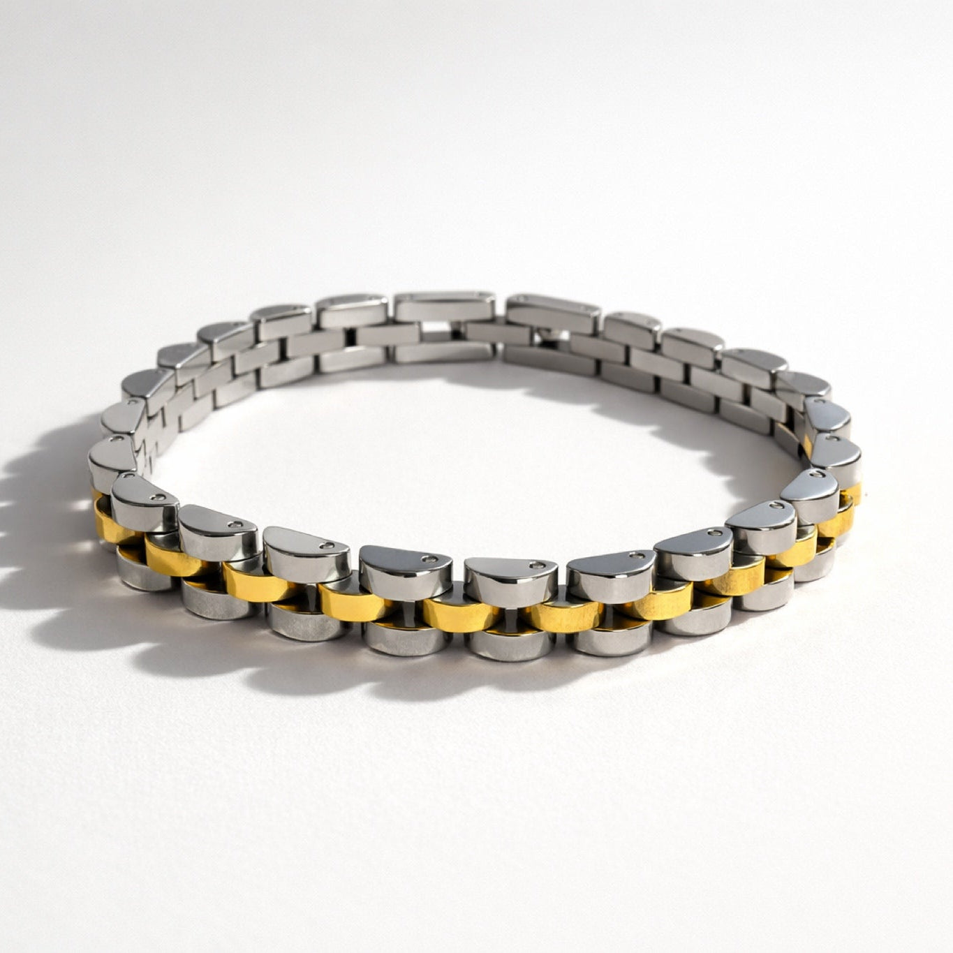 Trendy two-tone gold and silver bracelet with chunky link design and polished finish