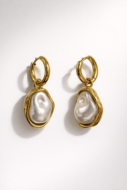 Gold hoop earrings with organic pearl drop pendants and a high-shine polished finish
