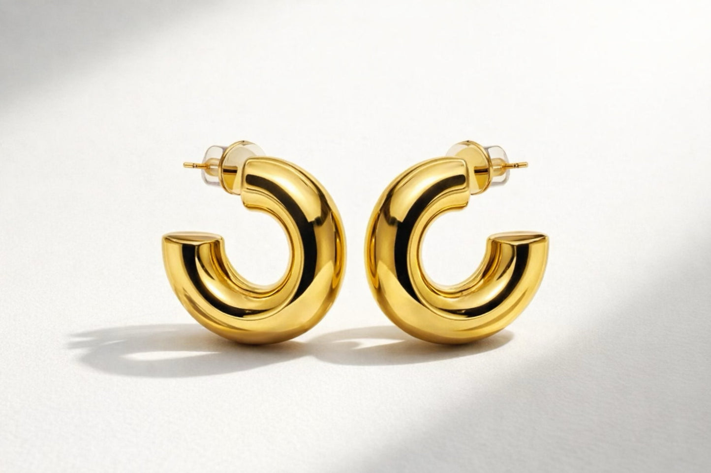 Trendy chunky gold hoop earrings with a smooth, high-shine polished finish
