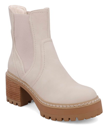 Ecru faux leather Chelsea ankle boot featuring elastic side panels, a chunky lug sole, stacked block heel, and round toe for a modern, versatile everyday style.