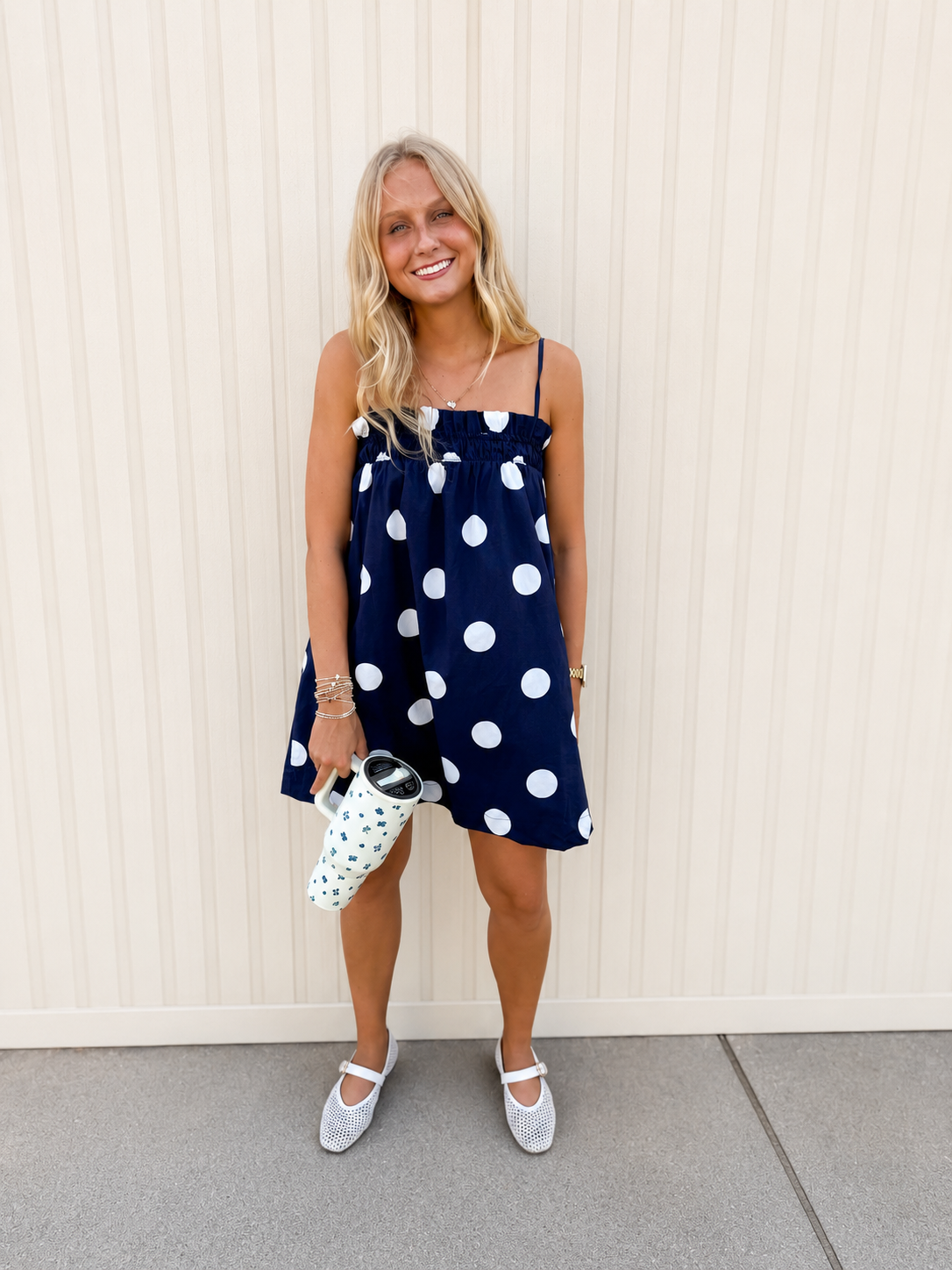Shop our Navy Polka Dot Babydoll Dress. Featuring a smocked neckline and breezy fit, it’s the ultimate easy-wear mini for summer vacations and brunch.