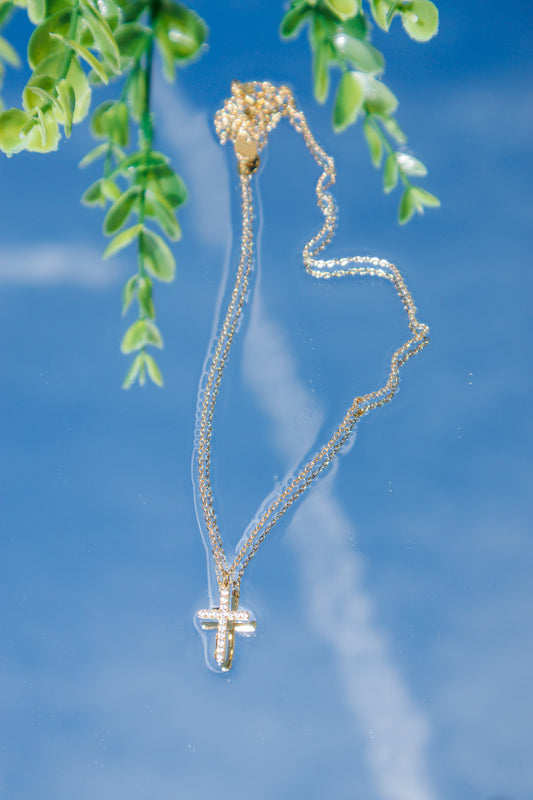 Radiant Faith Gold Pavé Cross Necklace featuring a sparkling pavé cross pendant on a delicate gold chain, waterproof and tarnish-resistant Christian jewelry with a lifetime warranty.