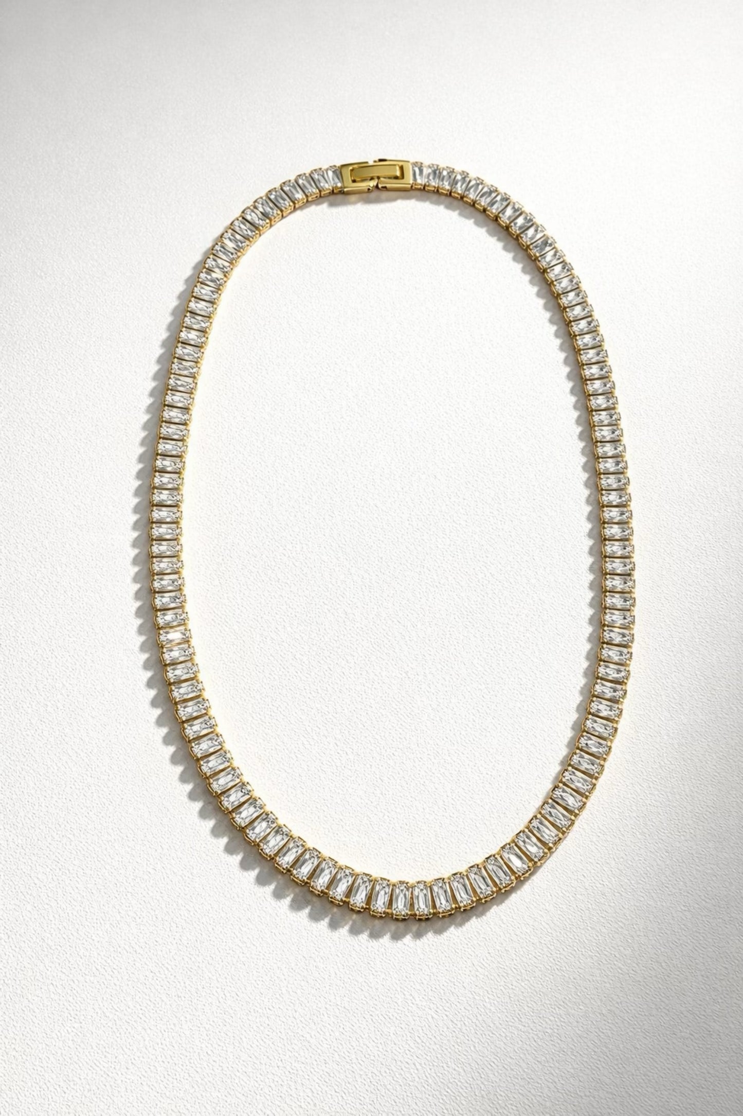 Radiant Virtue baguette tennis necklace with gold chain and rectangular crystal stones, elegant statement jewelry