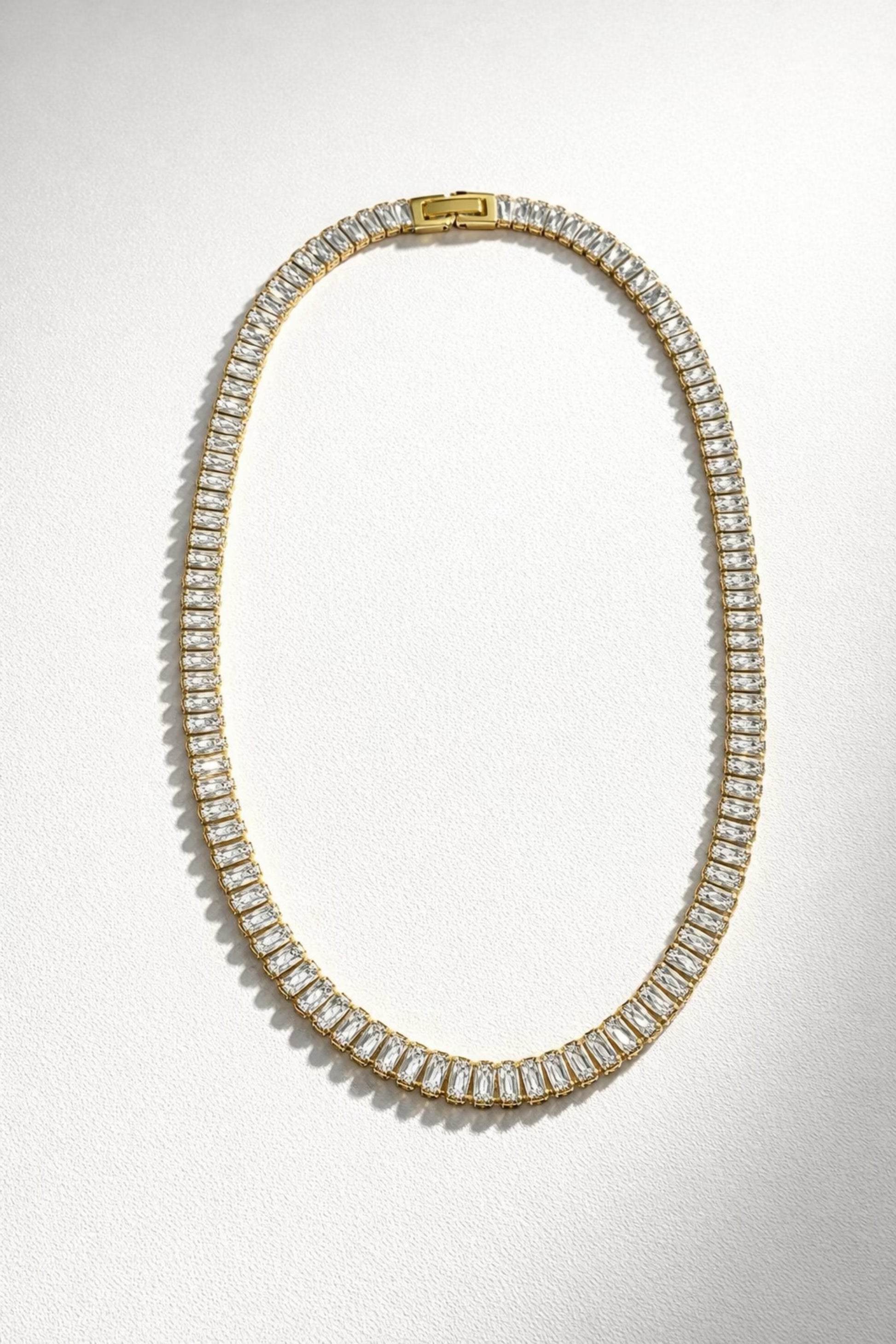 Radiant Virtue baguette tennis necklace with gold chain and rectangular crystal stones, elegant statement jewelry