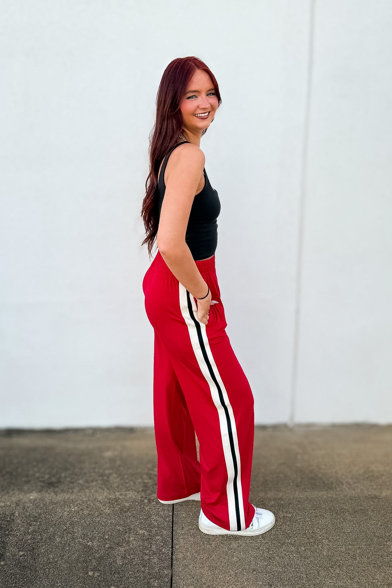 Shop the Trackside Stripe Wide-Leg Pants. Ultra-soft stretch, chic side stripes, and a flattering fit perfect for travel, tailgates, and effortless style.