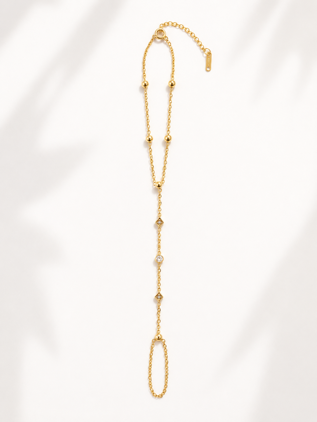 Righteous Right Hand Chain featuring a delicate gold hand chain with sparkling crystal accents, connecting the wrist to the finger, inspired by Isaiah 41:10, waterproof, tarnish resistant, hypoallergenic, and backed by a lifetime warranty.
