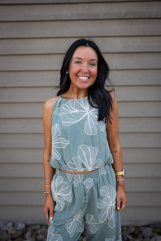 Shop the Sage Garden Linen Halter Top. Featuring cream floral embroidery and a trendy bubble hem. The perfect breathable, chic choice for your next getaway!