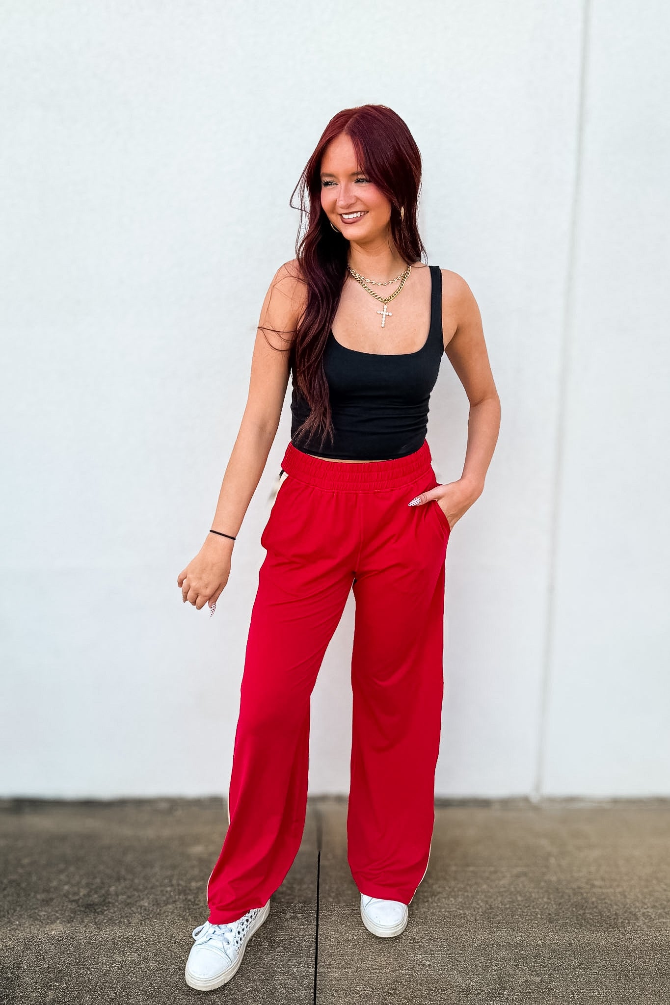 Shop the Trackside Stripe Wide-Leg Pants. Ultra-soft stretch, chic side stripes, and a flattering fit perfect for travel, tailgates, and effortless style.