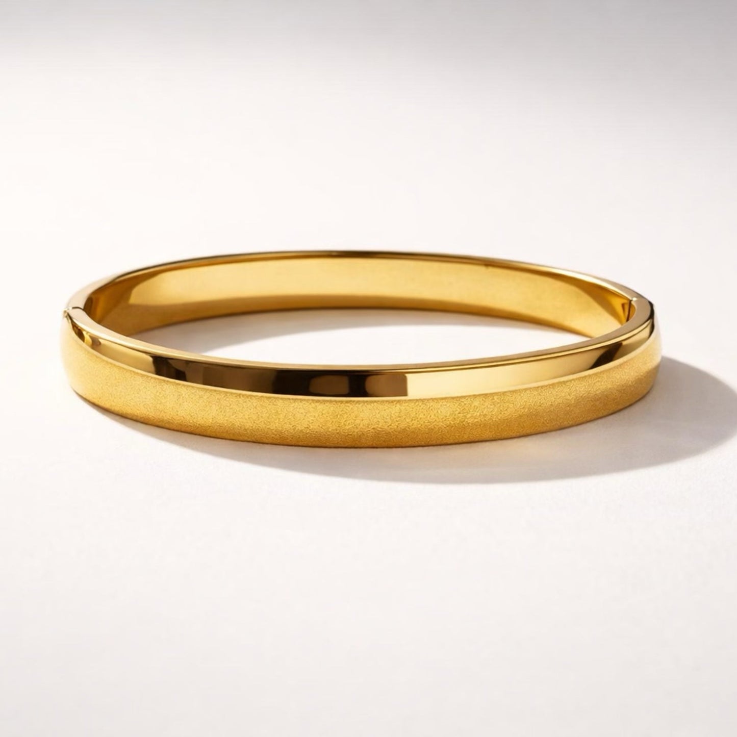 Trendy gold bangle bracelet with dual finish design, polished center and matte textured sides